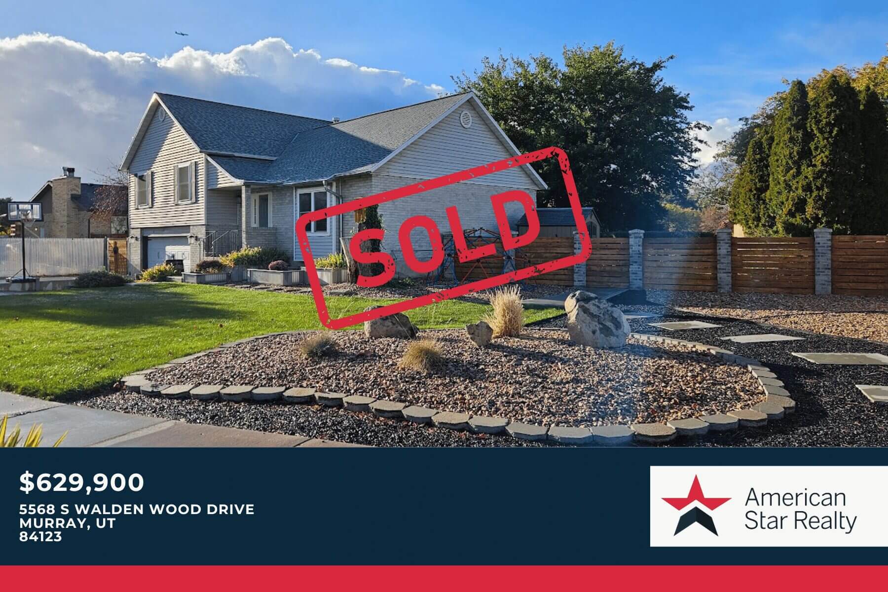 House with "SOLD" sign in front yard.