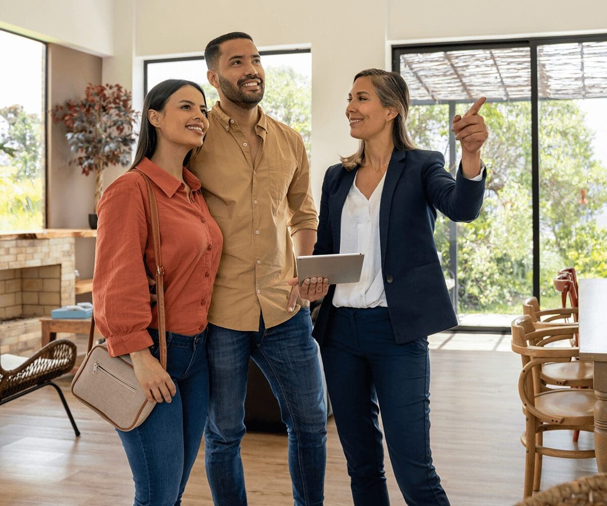 Couple touring house with real estate agent.